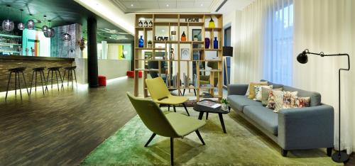a living room with a couch and chairs at Holiday Inn Express Hasselt by IHG in Hasselt