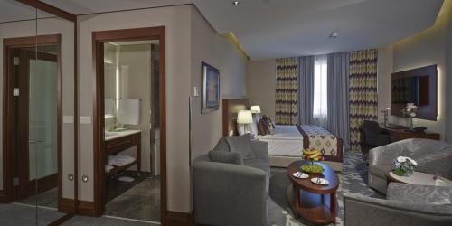 a living room with a couch and a bed at Crowne Plaza Istanbul Oryapark by IHG in Istanbul