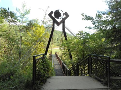 a statue of a person on a suspension bridge at Holiday Inn Express Hocking Hills-Logan by IHG in Logan