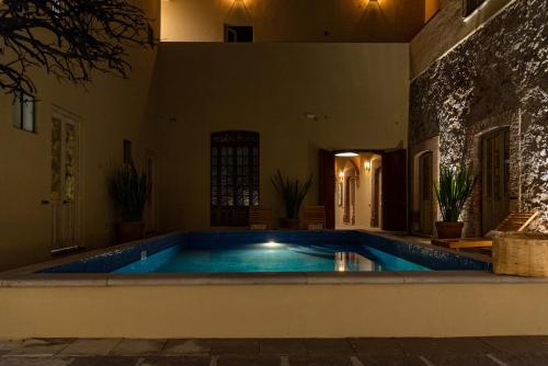 a swimming pool in the middle of a house at Hotel Nena Centro in San Miguel de Allende