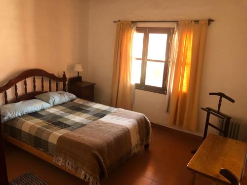 1 dormitorio con cama y ventana en La Estancia en Maimará