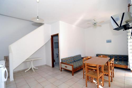 a living room with a table and a couch at Evilion hotel in Stalos
