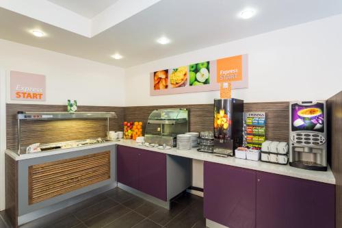 a fast food restaurant with a counter with a food at Holiday Inn Express Harlow, an IHG Hotel in Harlow
