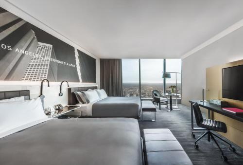 a hotel room with two beds and a flat screen tv at InterContinental - Los Angeles Downtown by IHG in Los Angeles
