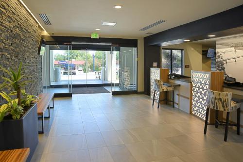 a lobby with a table and chairs in a building at Staybridge Suites - Little Rock - Medical Center by IHG in Little Rock