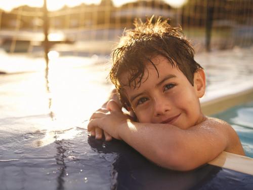 a young boy laying in a swimming pool at Holiday Inn Chennai OMR IT Expressway by IHG in Chennai