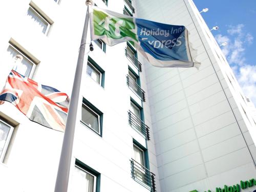 a building with flags in front of it at Holiday Inn Express London Croydon, an IHG Hotel in Croydon