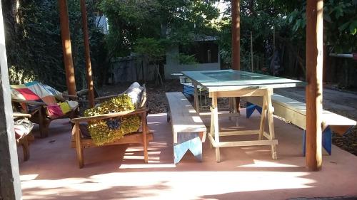 a ping pong table and chairs on a patio at Quitinetes Rusticas Junto a Natureza - Bruxas e Bruxos in Porto Seguro
