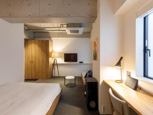 Tempat tidur dalam kamar di Hotel Mei Fukuoka Tenjin