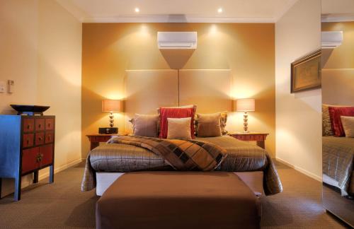 a bedroom with two beds and a dresser at 53 on Victoria in Warwick