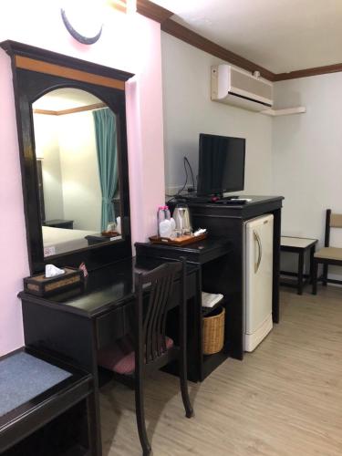 a room with a vanity with a mirror and a television at Wan Wan Place in Ao Nang Beach