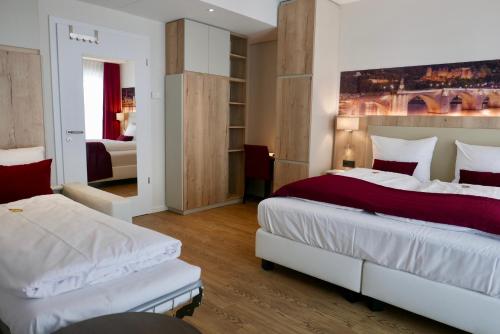 A bed or beds in a room at Rafaela Hotel Heidelberg