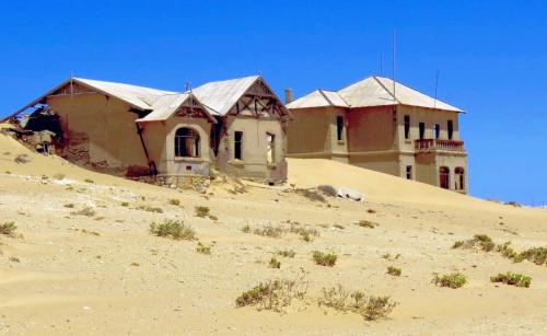 a building on top of a hill in the desert at OceanLife Guesthouse and Restaurant Lüderitz in Lüderitz