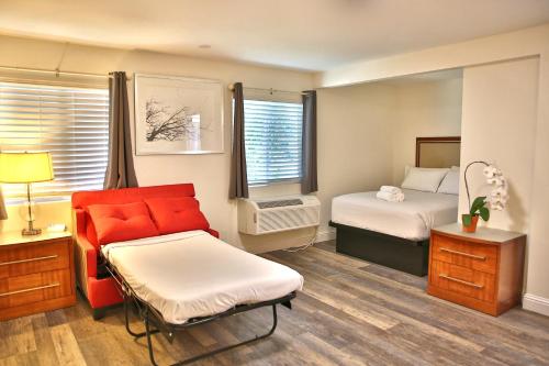 a hotel room with a bed and a couch at Travelodge by Wyndham Crescent City in Crescent City