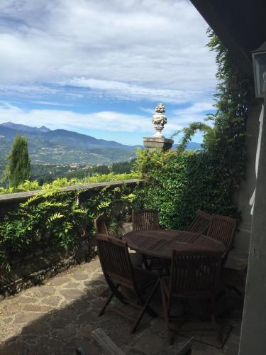 a table and chairs on a patio with a view at Belvedere in Coreglia Antelminelli