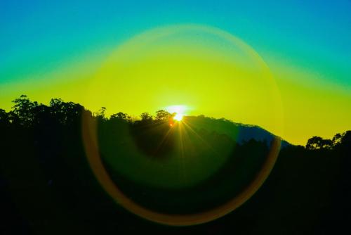 a sunset with the sun setting in the background at Senasuma Inn Ella in Ella