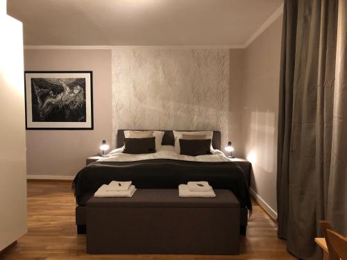 a bedroom with a large bed with two towels on it at Domaine La Reveille in Dore-lʼÉglise
