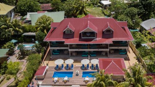 an aerial view of a resort with a red roof at Casa De Leela Self Catering Guest House in La Digue