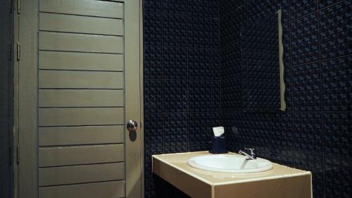 a bathroom with a sink and a mirror at Checkinn Resort Kanchanaburi in Kanchanaburi
