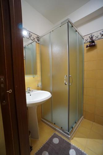 a bathroom with a shower and a sink at Aretè Apartments in Lecce