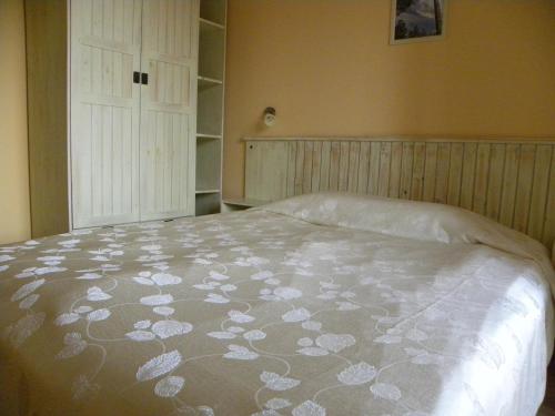 a bedroom with a bed with a white comforter at Saint Ivan Ski Apartments in Bansko
