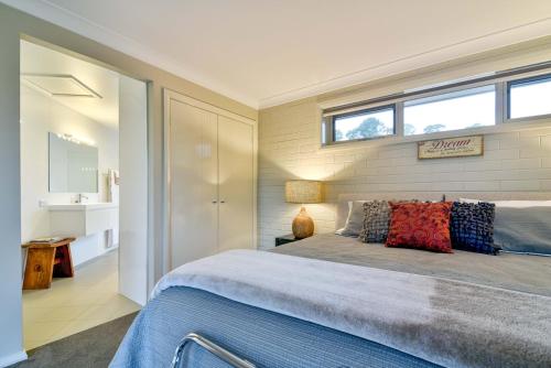 a bedroom with a large bed with a window at Lakeview Luxury Retreat in Orange