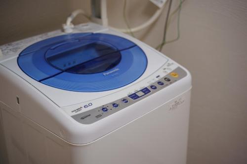 a washing machine with a blue plate on top of it at Coto in Miyazu