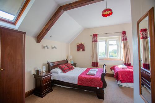 a bedroom with two beds and a window at The Beacon & Railway Hotel in Stonehouse