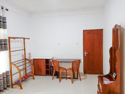 a room with a table and two chairs and a ladder at Heaven Hills Guest House in Maskeliya