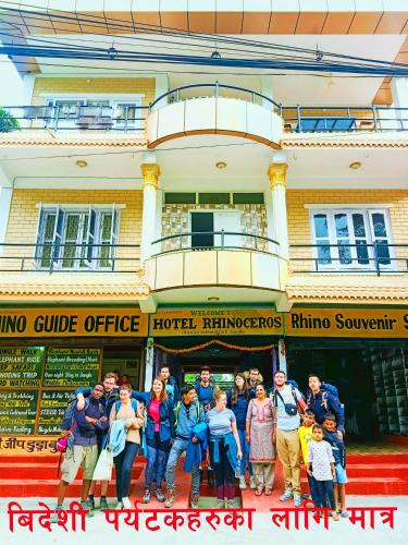 a group of people standing in front of a building at Hotel Rhinoceros-Homestay in Sauraha