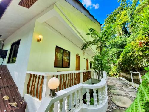 a house with a staircase leading to a balcony at Cocoloco Beach Resort in Boracay
