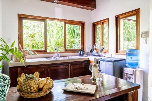 a kitchen with a basket of fruit on a table at Greenhouse Siargao Eco-Beach Resort in General Luna
