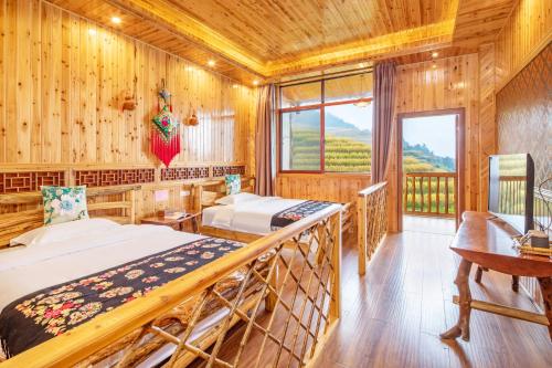 Postel nebo postele na pokoji v ubytování Long An Hotel 龙胜龙安酒店
