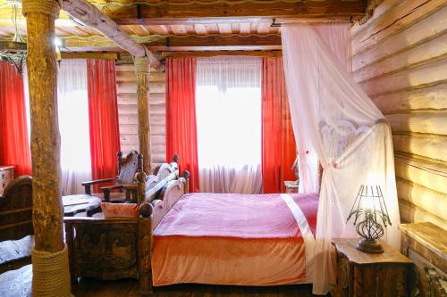 a bedroom with a bed in a log cabin at ООО РГК Русская охота in Penza