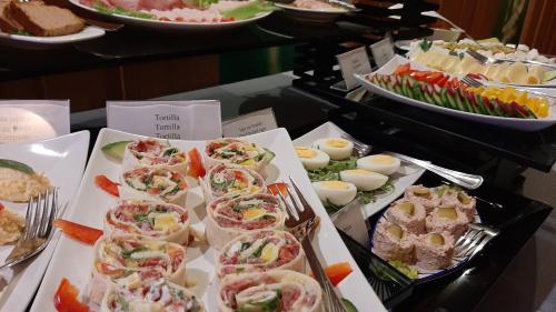 a buffet filled with different types of sandwiches and other foods at Hotel Active in Szczecinek