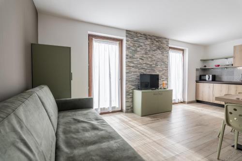 a living room with a couch and a kitchen at Residence Arnica in Celledizzo