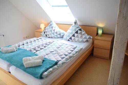 a bedroom with a bed with blue and white pillows at Ferienwohnung Hafenwestseite Neustadt in Neustadt in Holstein