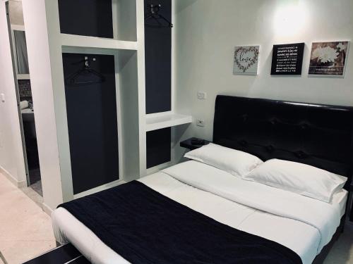 a bedroom with a bed with a black headboard at Hôtel le calife in Tunis