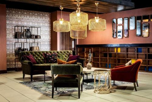 a living room with a couch and a table and chairs at Waterfront Southport Hotel in Southport