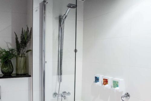 a shower with a glass door in a bathroom at Waterfront Southport Hotel in Southport