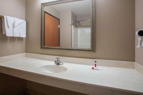 a bathroom with a sink and a mirror at Super 8 by Wyndham Union in Union
