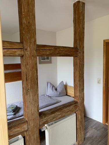 a room with two bunk beds and a radiator at Landgasthof Wetteraperle in Raila