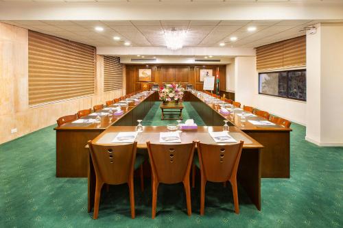 a large conference room with long tables and chairs at Amman International Hotel in Amman