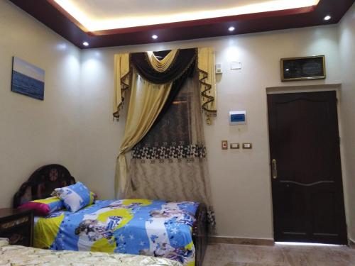 a bedroom with a bed and a window at Safari Abu Simbel in Abu Simbel