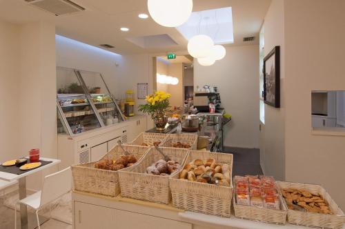 a bakery with several baskets of donuts on a counter at Hotel Sempione in Milan