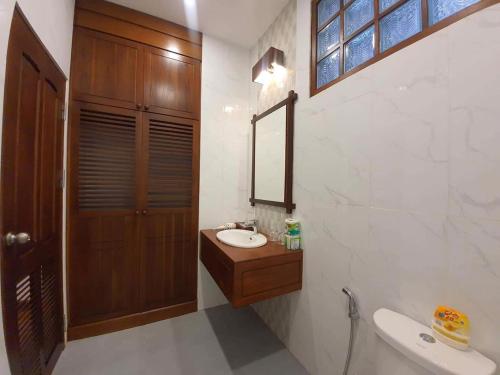 a bathroom with a sink and a mirror at Villa Chitchareune 2 in Luang Prabang