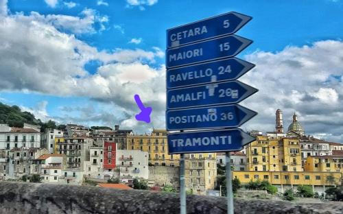 a street sign in front of a city with buildings at Casa Panorama Amalfi Coast in Vietri sul Mare