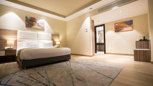 a bedroom with a large bed and a large rug at Golden Jewel Beach&Hotel in Alexandria