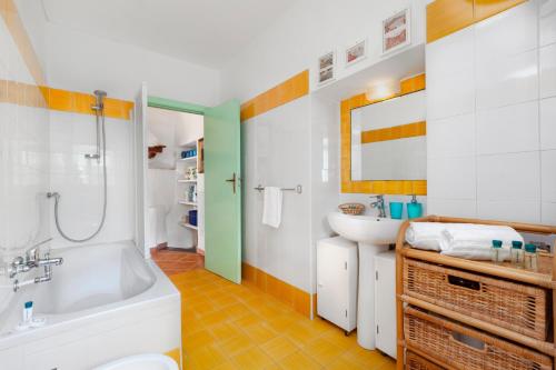 a bathroom with a tub and a sink at Gaiano Apt in Sorrento