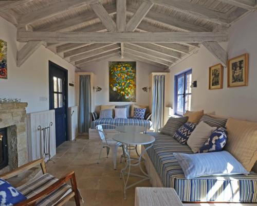 a living room with a couch and a table at Apokryfo Traditional Guesthouse in Lofou